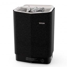 Un sauna Poêle Tylö Sense Combi Pure noir avec une partie supérieure blanche contenant des pierres de sauna. Le design élégant et rectangulaire est doté de la technologie avancée Sense Combi Elite et comprend un bouton de commande situé en bas à droite.